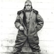 William Hopson, a white man, stands while wearing aviator gear.