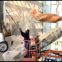 Brenda Averett protecting aircraft in the Boeing Milestones of Flight Hall