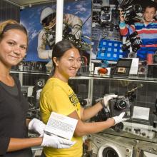 Museum Specialist installing the Space Camera Exhibit Case