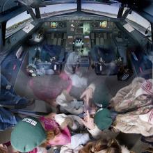 America by Air - cockpit reflecting children