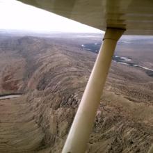 View of a mountain and valley from an airplane.