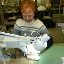 Ruth Ratledge repairing Spacesuit