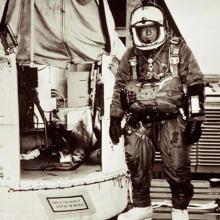 Joseph Kittinger suited and standing next to Excelsior gondola