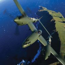 Glacier Girl P-38 in flight over coastline