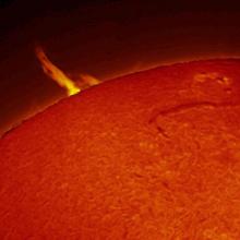 Partial view of the Sun which highlights a large prominence of plasma.