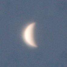 View of Venus as a waning crescent during daytime hours.