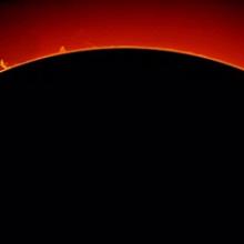 View of multiple large prominences of plasma floating away from the Sun.