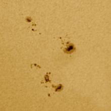 A close-up view of two groups of sunspots on the Sun.