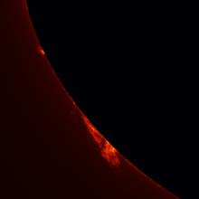 Partial view of the Sun's surface with an emphasis on two prominences floating away from the surface of the Sun.