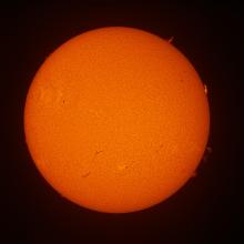 Disk view of the Sun with multiple large prominences visible on the right side of the Sun.