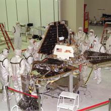 Workers in the Jet Propulsion Laboratory work to prepare the Mars Pathfinder Lander before its flight to Mars.