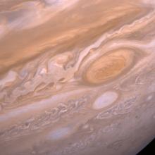 A portion of the gaseous surface of Jupiter with its Great Red Spot on the right side. 