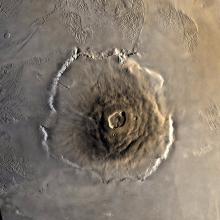 A satellite view of a large volcano on the surface of Mars.