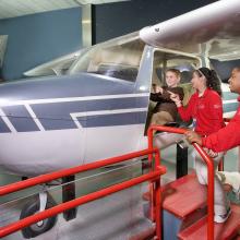 Explainers Assist a Young Visitor in the How Things Fly