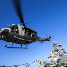 The bottom view of a helicopter taking off. 