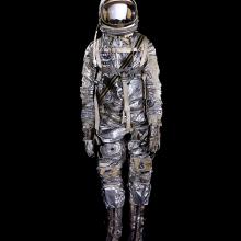 Spacesuit made of aluminized fabric with boots, gloves, and helmet on mannequin