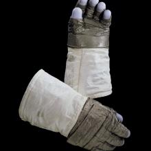 Pair of lunar gloves used on Apollo 11 mission. A special gray fabric makes up most of the gloves with the blue fingertips made from silicon rubber.