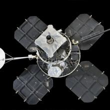 Lunar lander with four square solar panels attached to central instrument box and round satellite dish