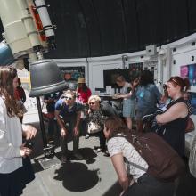 teachers look through telescope