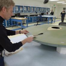 A Museum conservation specialist tries to find the correct paint color for a gray spaceship studio model used in the television series Star Trek