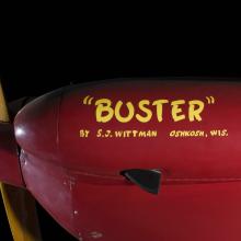 Side of nose of red Wittman Special 20 "Buster" aircraft with ""Buster"" and identification in yellow lettering