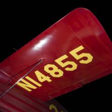 Wing of red Wittman Special 20 "Buster" aircraft with "NI4855" in yellow lettering