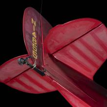 Tail of red Wittman Special 20 "Buster" aircraft with small rear wheel and "NI4855" in yellow lettering