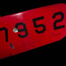 Under wing of red Amelia Earhart Lockheed Vega 5B aircraft with "7952" in black letters