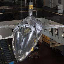 Tip of black titanium rocket-shaped North American x-15 aircraft hanging in museum