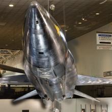 Tip of black titanium rocket-shaped North American x-15 aircraft hanging in museum