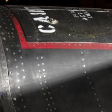 Red square outline and "Caution" in white lettering on black titanium North American x-15 aircraft