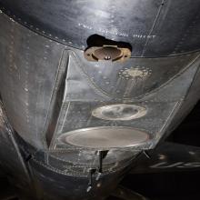 Circular metal plates and apparatuses on bottom of North American x-15 aircraft