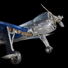 Front of metalic silver and blue Hughes H-1 Racer aircraft with propeller and engine