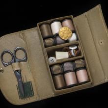 Rectangular box with thread spools, needles, buttons, and scissors