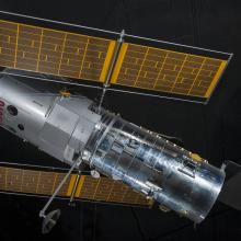 Side view of metal Hubble Space Telescope Model with yellow solar panels