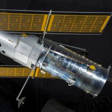 Side view of metal Hubble Space Telescope Model hanging in museum