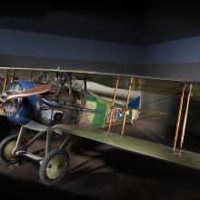 Green and brown Spad XIII "Smith IV" biplane in museum