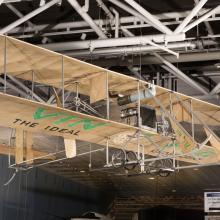 Wood and fabric Wright EX Vin Fiz biplane hanging in museum