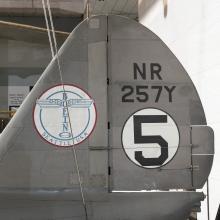 Boeing logo and "NR257Y" with "5" in white circle on vertical stabilizer on gray Boeing 247-D aircraft