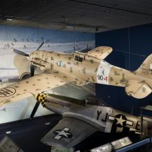 Side of tan Macchi C.202 Folgore aircraft hanging in museum