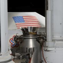 Gas chromatography?mass spectrometry (GCMS) metal part of Viking Mars Lander with American flag sticker in background part of vehicle