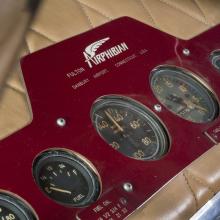 Close up view of the instrument panel of a airplane. The panel display fuel level, miles per hour, and other panels.