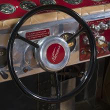 View of a steering wheel connected to an instrument panel on a plane.