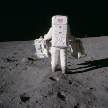 Buzz Aldrin carrying experiments on the surface of the Moon