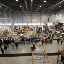 Second-floor view of Museum visitors touring the Museum's restoration hangar during an open house event.