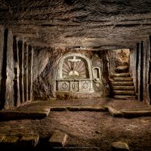 An underground chapel space carved during World War I. A set of stairs on the right of the altar allows for easy access to the trenches.