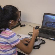 A student attending the "She Can" STEM camp flies a Cessna simulator at the Steven F. Udvar-Hazy Center.