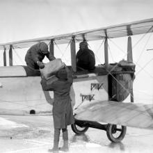 A photo of alcohol being unloaded from an airplane.