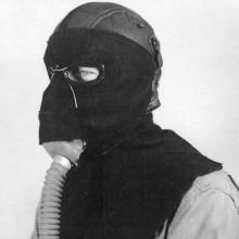 Member of the 390th Bomb Group, modeling a frostbite mask