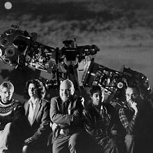 Five people posed in front of Zeiss projector